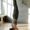 Woman performing a headstand in a well-lit yoga studio, demonstrating fitness and exercise after Botox treatment.