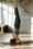 Woman performing a headstand in a well-lit yoga studio, demonstrating fitness and exercise after Botox treatment.